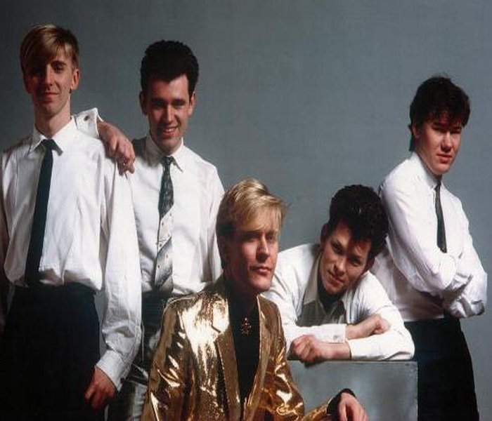 Martin Fry the lead singer of the Uk band that is - "ABC" - He is the one with the "Gold" suite in the middle of the picture