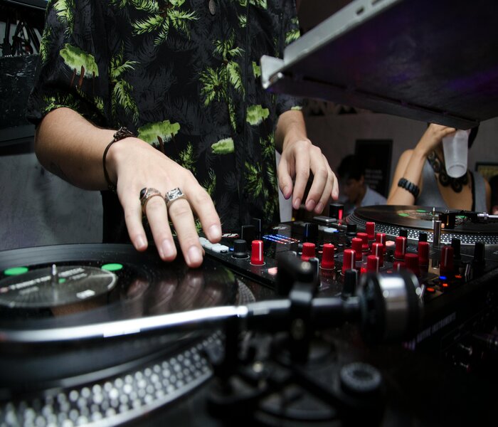 A dj working hard throught out the night and using vinyl records only